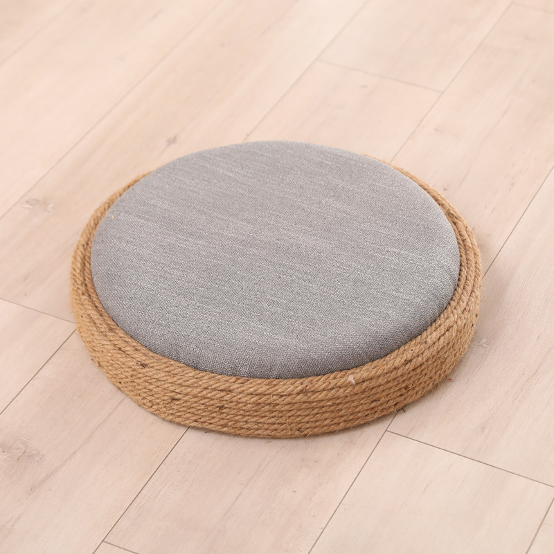 Grey round floor cushion with hemp rope border and linen cover, isolated view