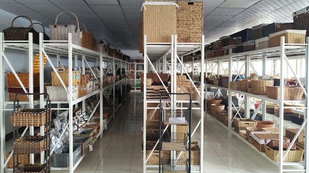 Multi-shelf showroom of handcrafted baskets at Woven Natural, displaying our complete rattan, rush and seagrass home decor range for wholesale buyers
