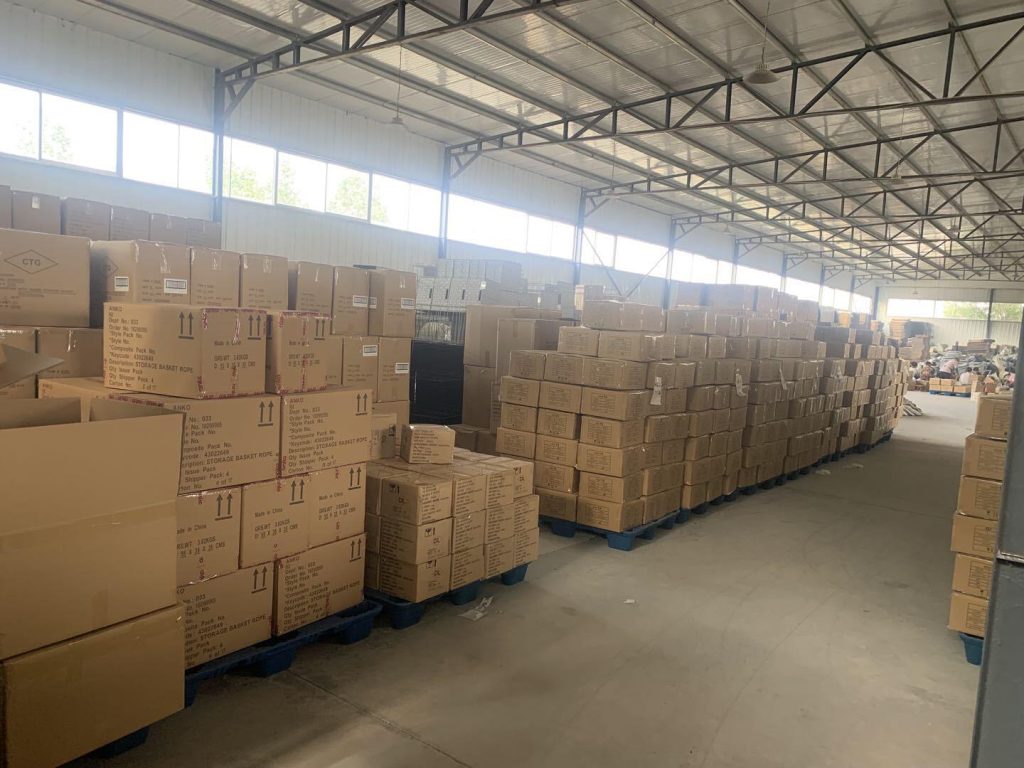 Palletized cartons of finished woven goods stacked inside Woven Natural dedicated packaging warehouse